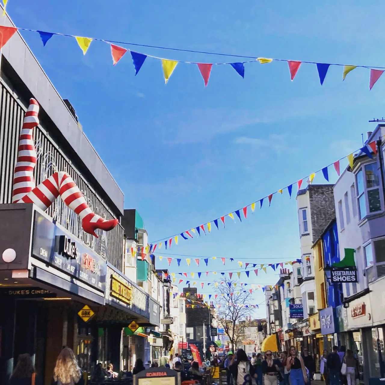 Gardner Street, North Laine Brighton in summer with cafe culture and colourful bunting